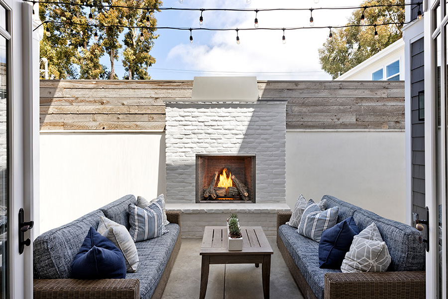 Outdoor fireplace with white brick trim