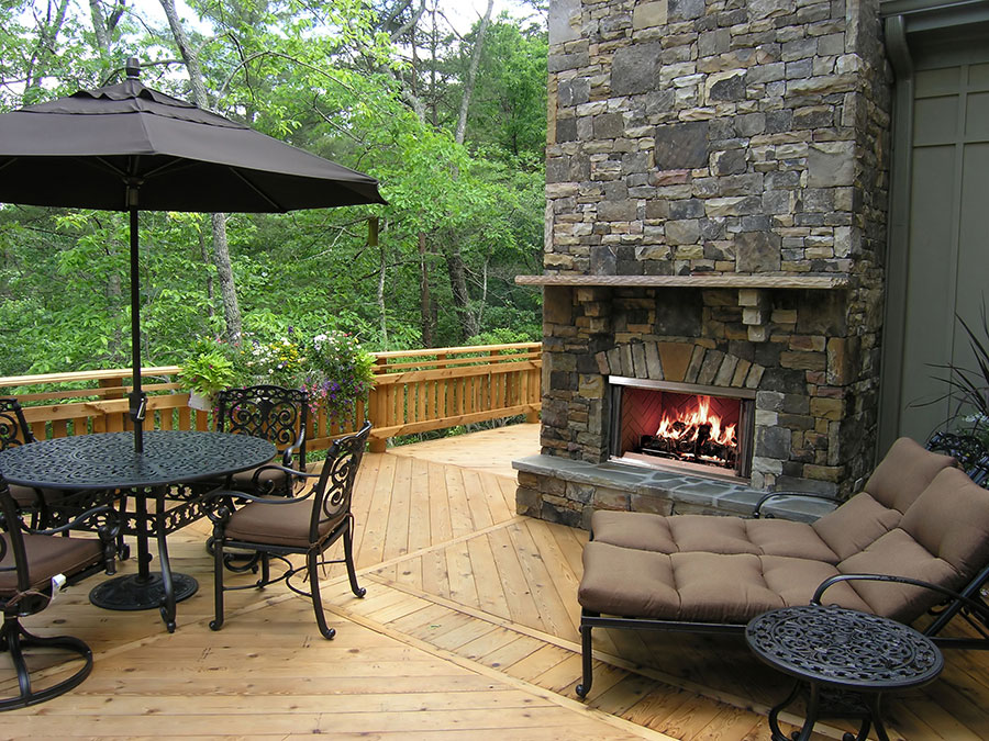 Outdoor fireplace with stone trim on a porch in montana