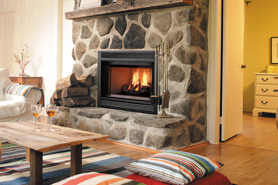 Wood fireplace with stone mantel and wooden logs